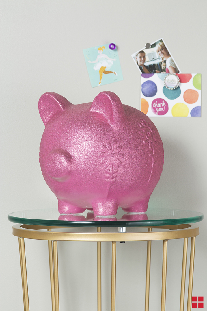 Piggy bank covered with pink glitter spray paint