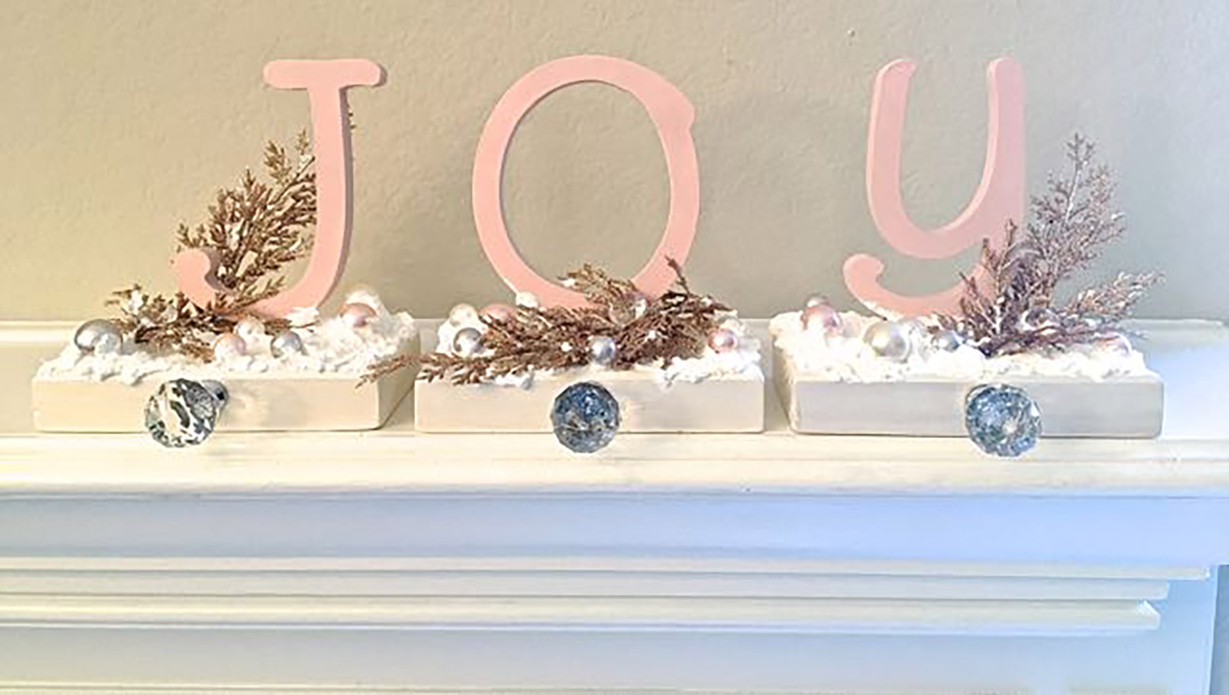 Three stocking holders that spell out the word “Joy.”